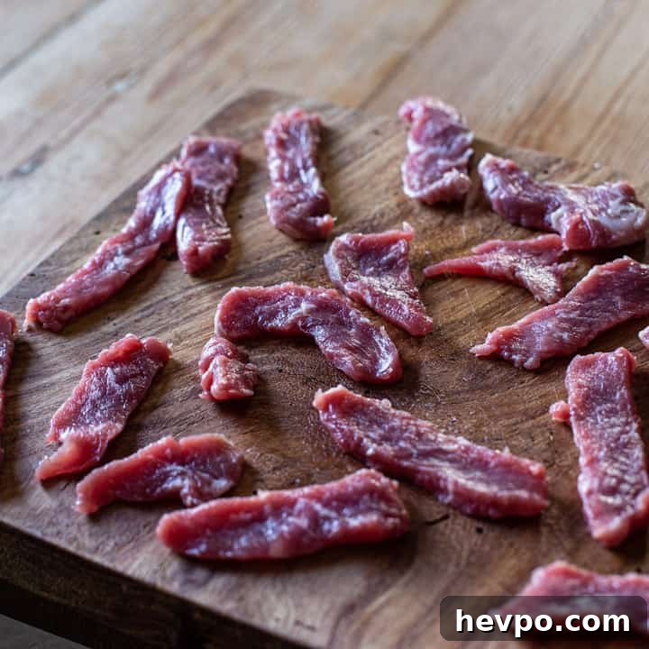 wooden board with small slices of sirloin steak