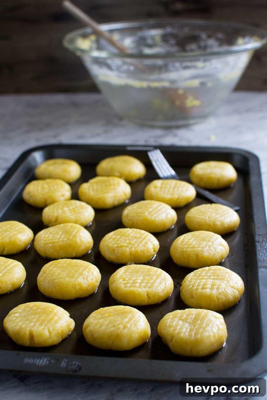 Melomakarona: Traditional Greek Christmas Honey Cookies Recipe 4 Raw Greek Christmas honey cookies on a baking tray ready to be baked