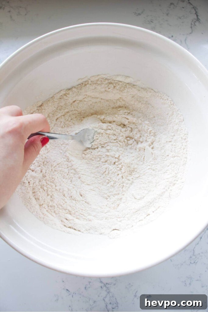 Crispy Korean Fried Chicken Recipe: Extra Crunch & Sticky Sauce 5 Fork mixing flour and spices for the fried chicken coating.