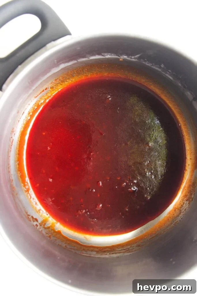 Crispy Korean Fried Chicken Recipe: Extra Crunch & Sticky Sauce 10 Sticky gochujang glaze in a small silver pot.