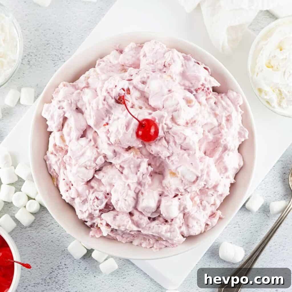 Light and Creamy Cherry Fluff Dessert Recipe 2 overhead view of cherry fluff in bowl topped with cherry