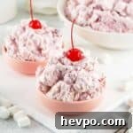 two bowls of cherry fluff topped with cherries