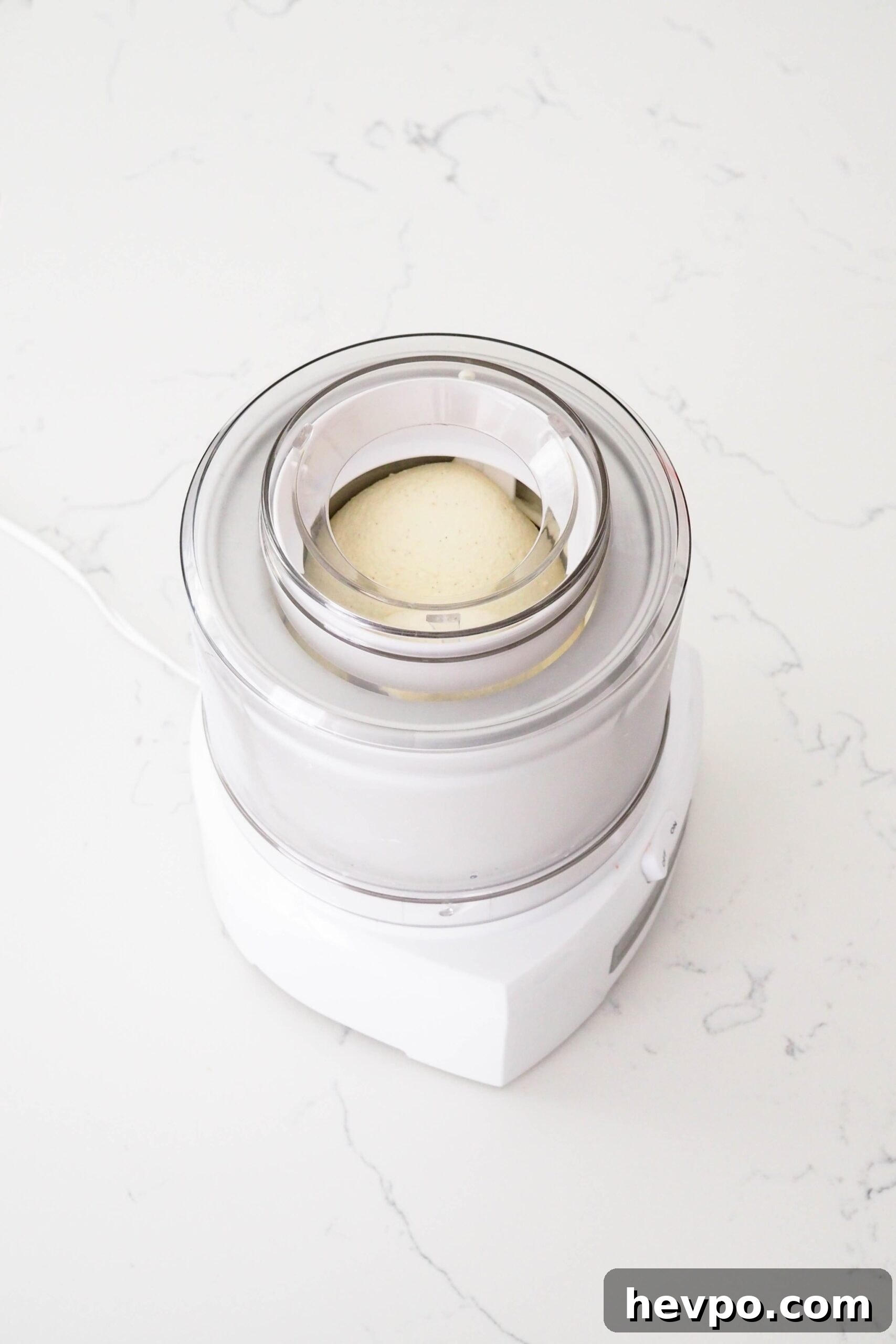 Homemade French Vanilla Ice Cream Recipe – Creamy & Classic 14 Ice cream in an ice cream maker with a lightly rounded dome.