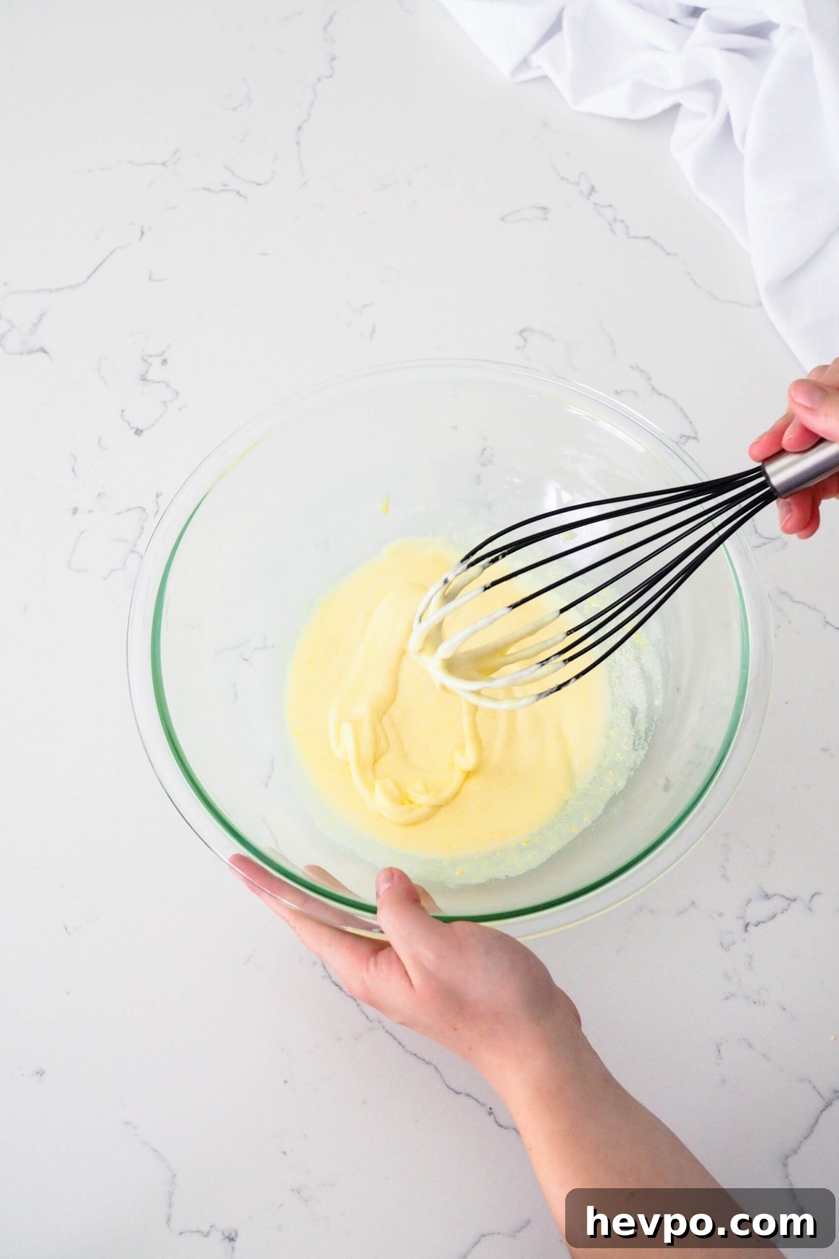 Homemade French Vanilla Ice Cream Recipe – Creamy & Classic 5 A ribbon of beaten eggs and sugar flows off a whisk in a bowl.