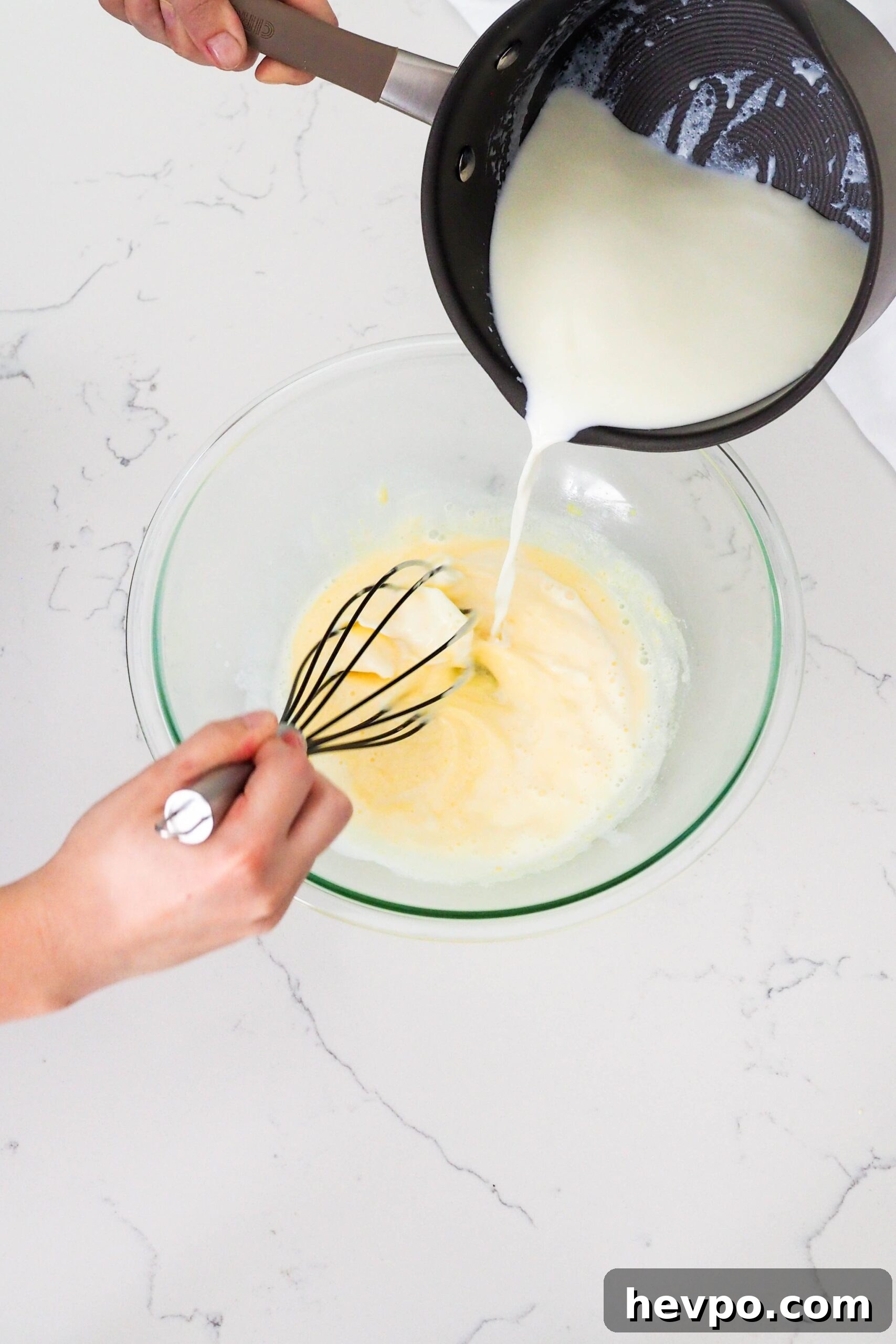 Homemade French Vanilla Ice Cream Recipe – Creamy & Classic 6 Hot milk and cream from a pot is whisked into egg yolks at the ribbon stage.