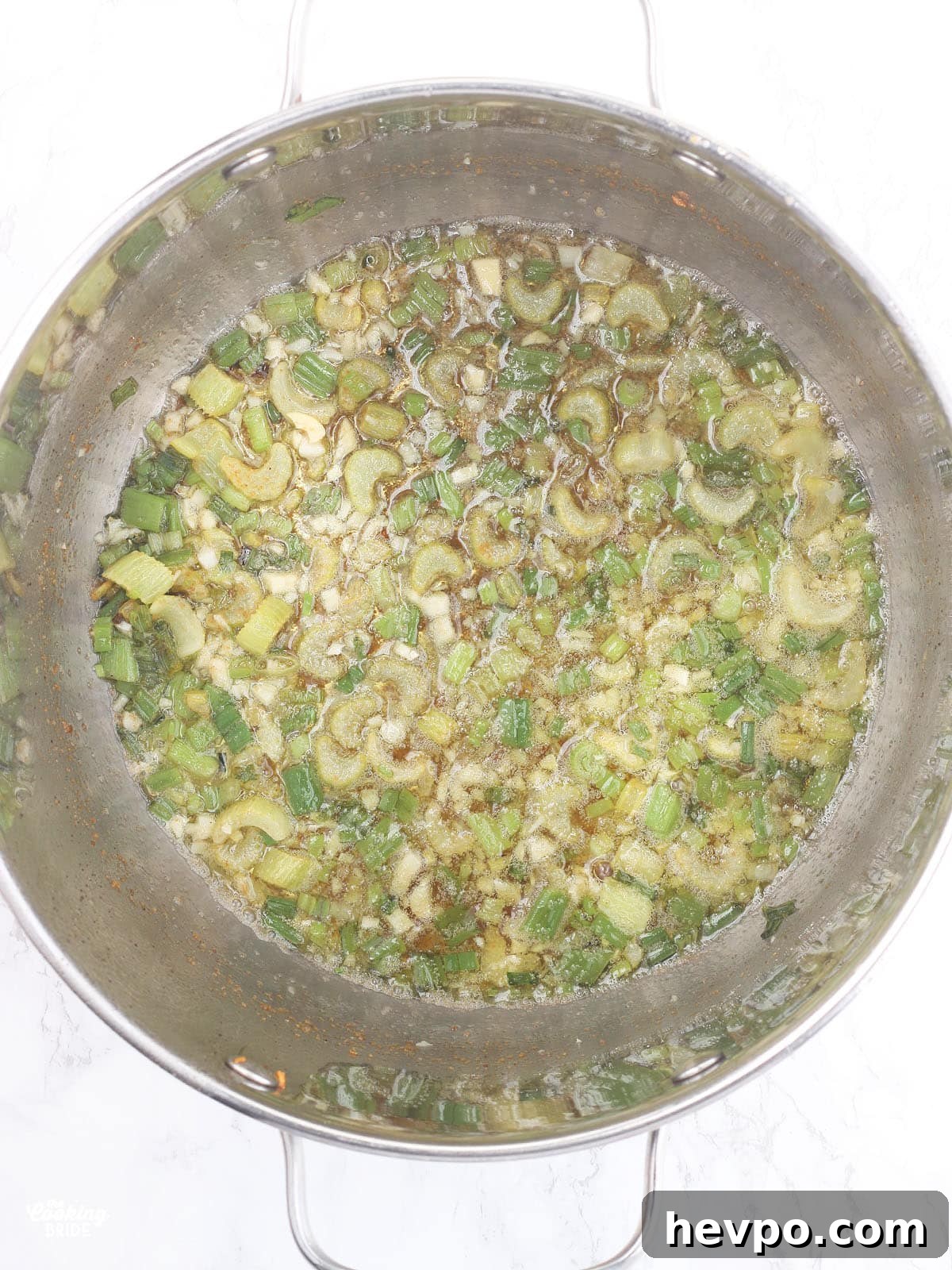 celery, green onions and garlic sautéed in butter in a steel stockpot