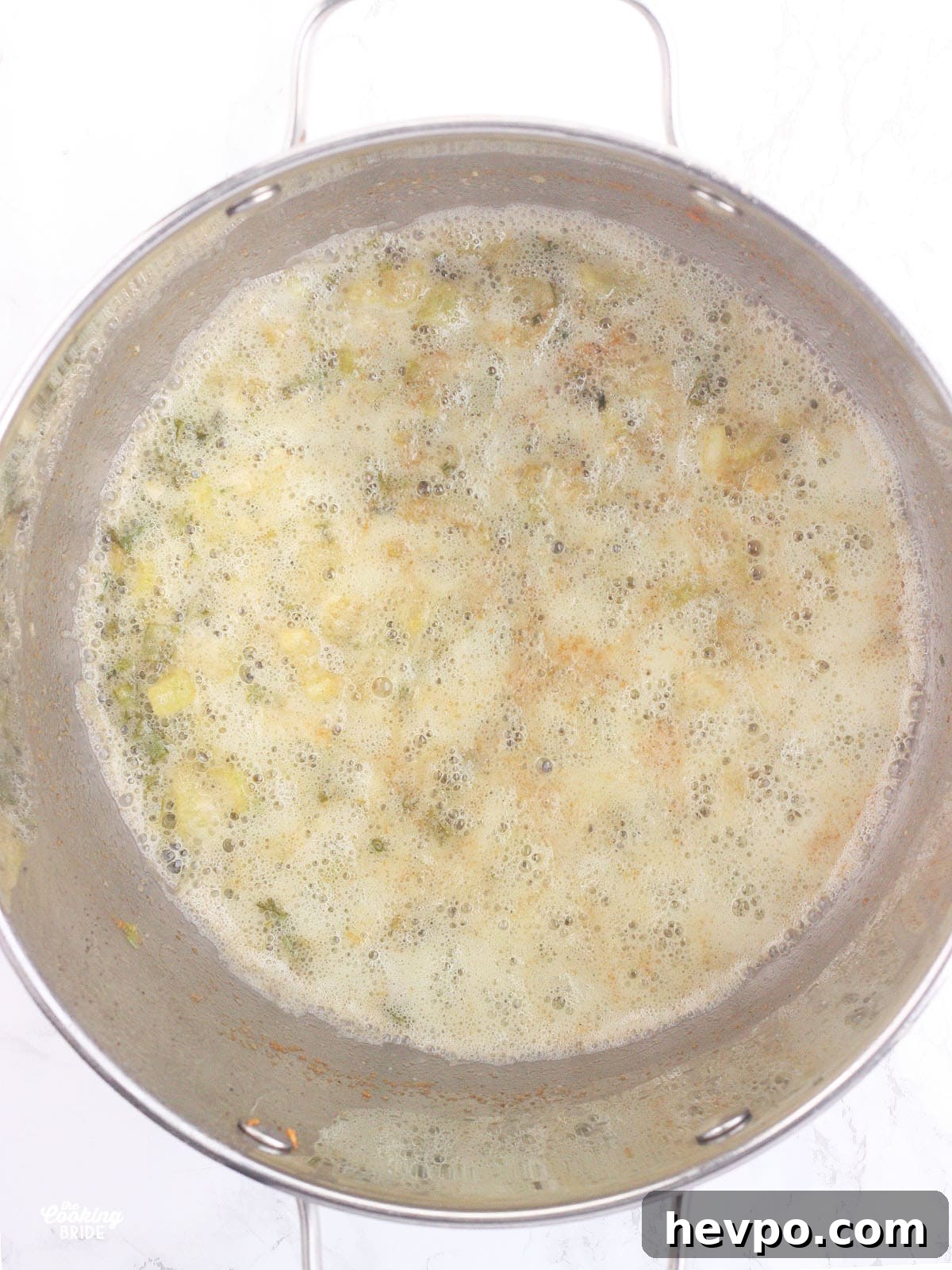 flour whisked in with sautéed vegetables in a steel stockpot