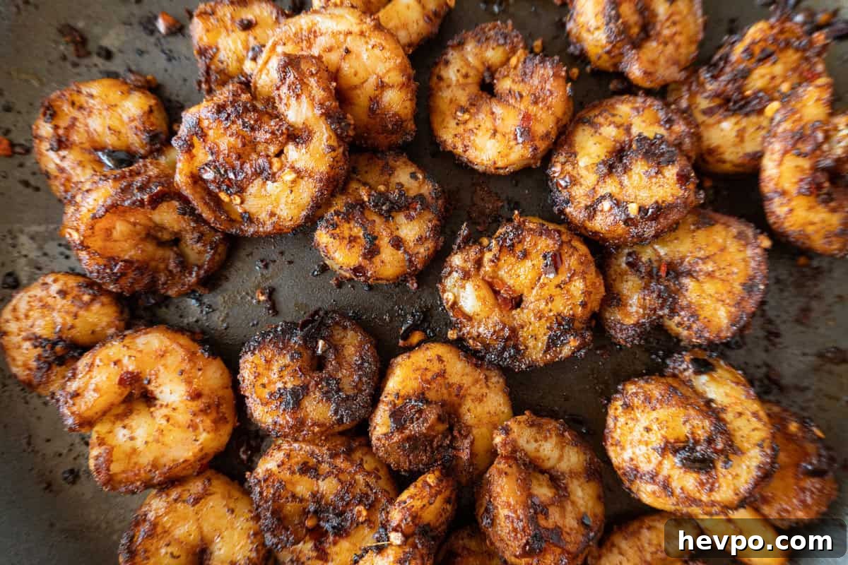 Spicy Blackened Shrimp Tacos with Avocado Lime Slaw 12 shrimp cooked in a non-stick pan, slightly charred.