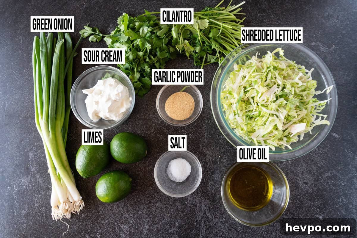 Spicy Blackened Shrimp Tacos with Avocado Lime Slaw 4 cilantro lime slaw ingredients in individual bowls and labeled.