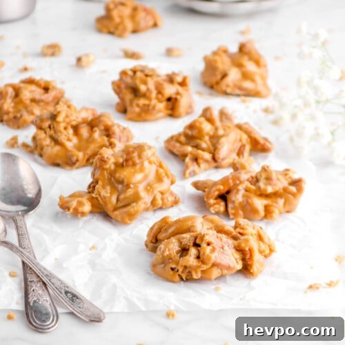 Southern Buttermilk Pecan Pralines Recipe – Classic Southern Candy 16 pecan pralines on parchment paper with two spoons and flowers behind