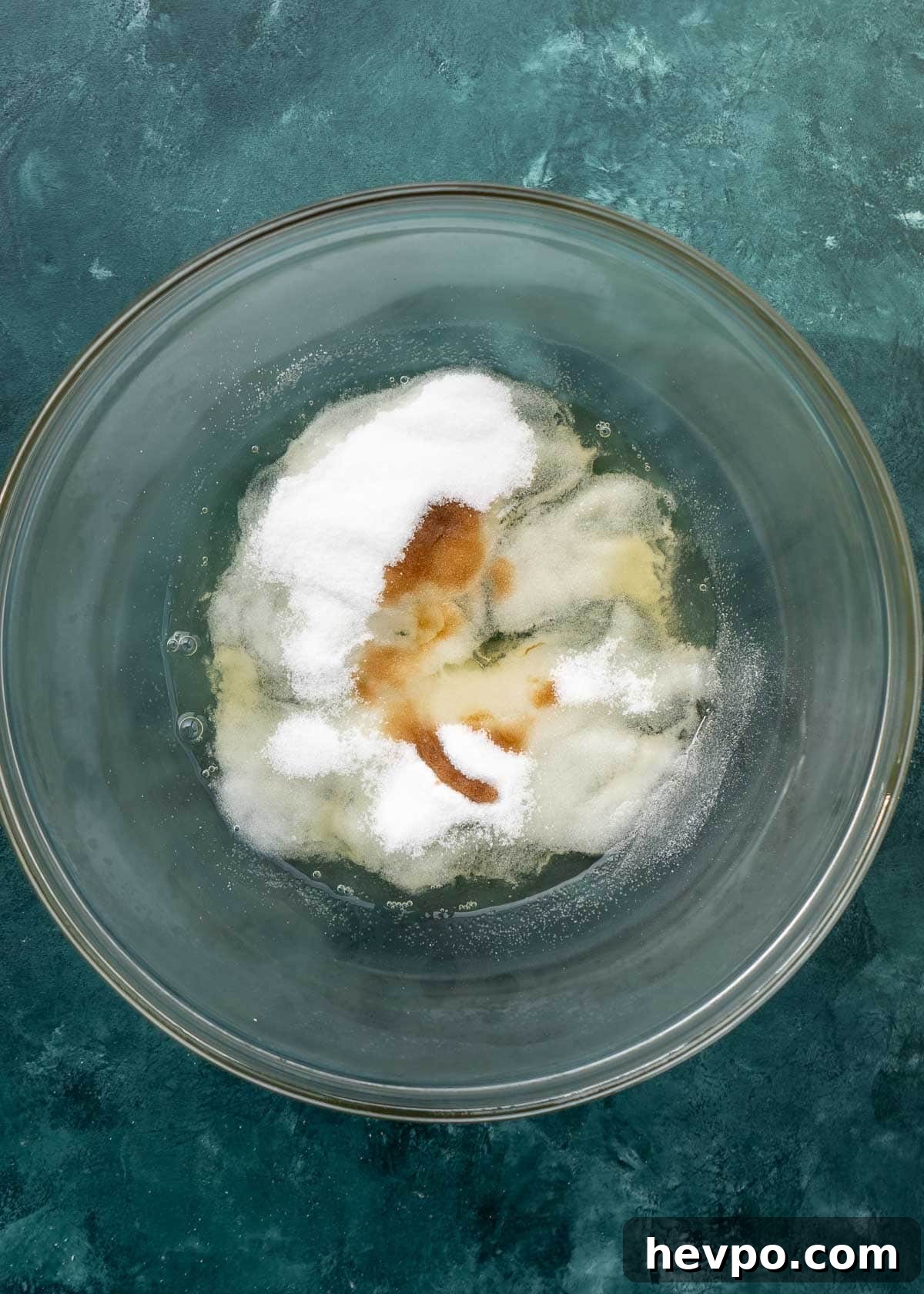overhead shot of coconut macaroon ingredients in clear mixing bowl