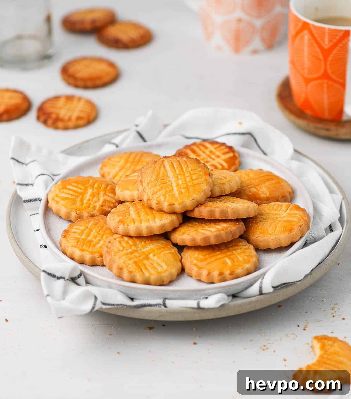 Classic French Sablés Bretons: Irresistible Salted Butter Cookies 7 Cookies on two white plates and white tea towel.