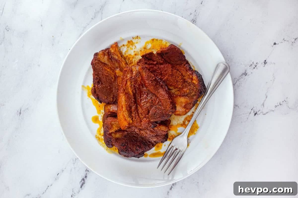 Top 10 Most Popular Recipes of 2022 You Need to Try 5 Slices of Pampanella Molisana, bright red slow-roasted pork in paprika on a plate with a fork