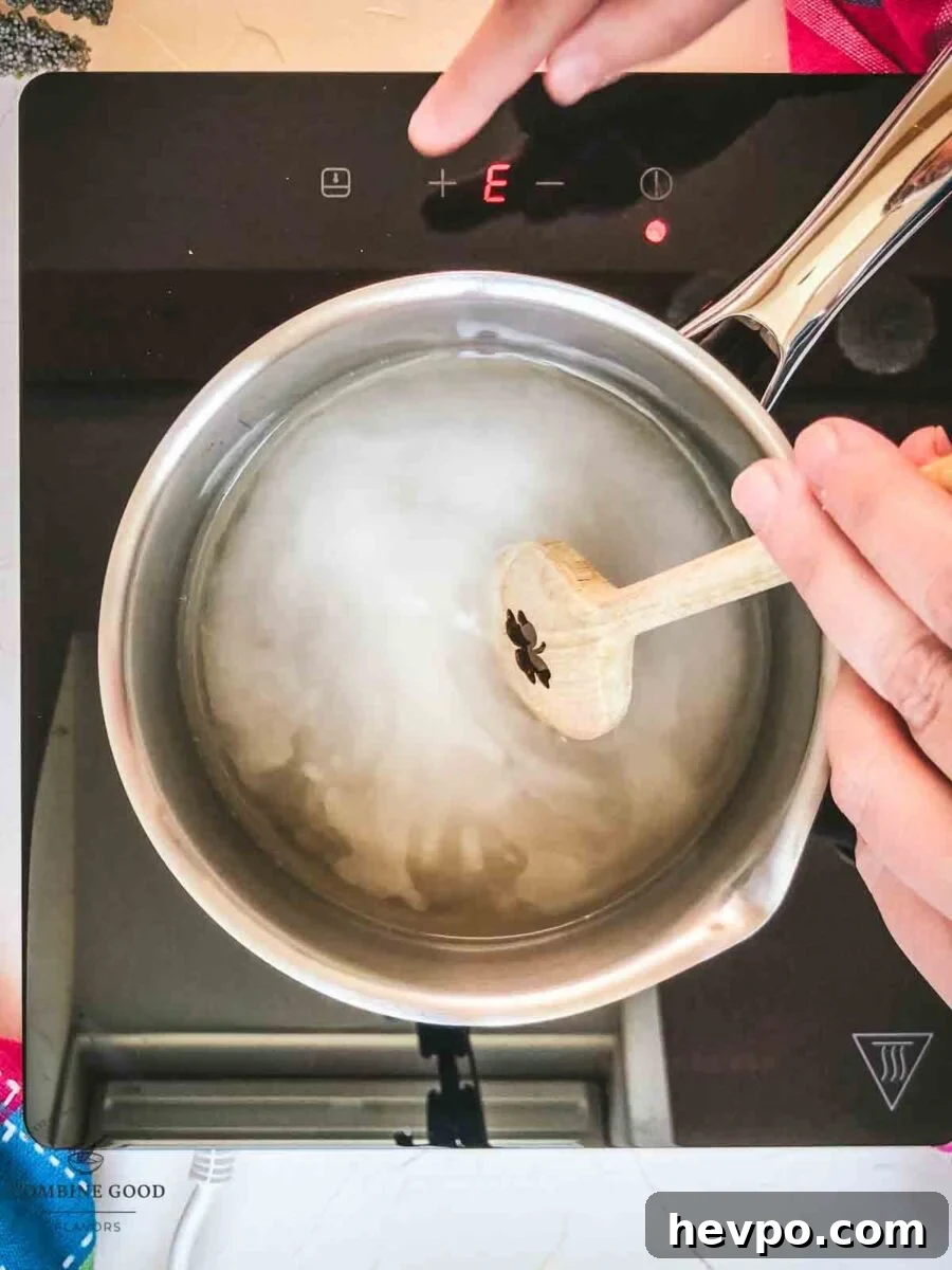 Stir the sugar water mixture, until the sugar is completely dissolved.