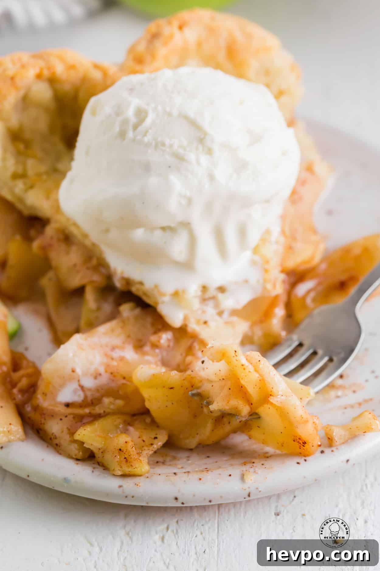 Apple Pie à la Mode: Classic Warm Apple Pie with Ice Cream 4 a slice of apple pie with cinnamon, topped with a scoop of vanilla ice cream.