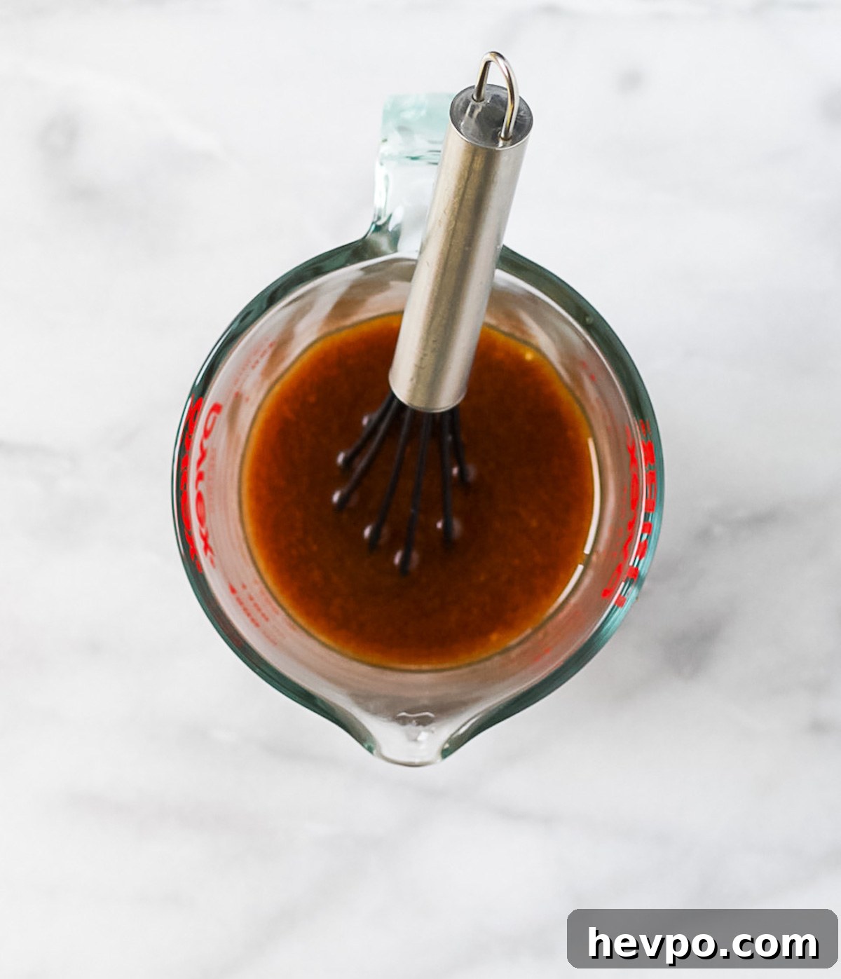 Sesame ginger salad dressing in a measuring cup