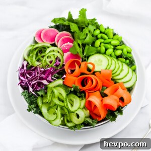A large salad consisting of kale greens, edamame,