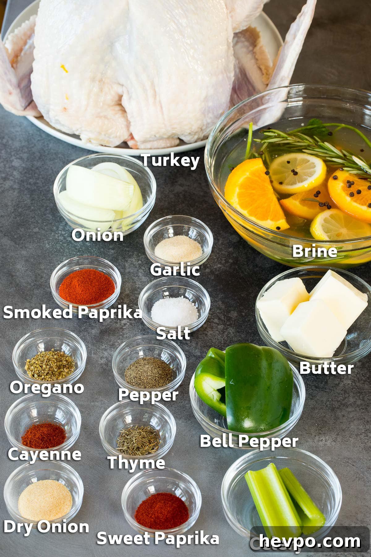 Cajun-Roasted Turkey Recipe for Bold, Spicy Flavor 3 Ingredients including a turkey, brine, bowls of seasonings and vegetables.