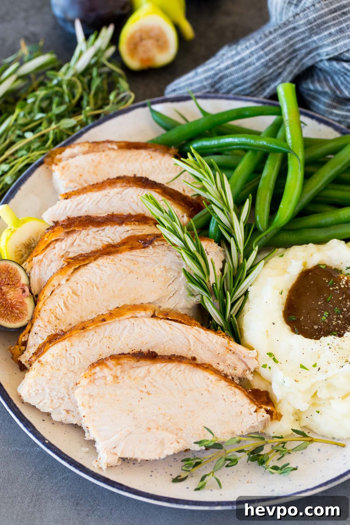 Cajun-Roasted Turkey Recipe for Bold, Spicy Flavor 6 Sliced Cajun turkey on a plate with mashed potatoes and green beans.