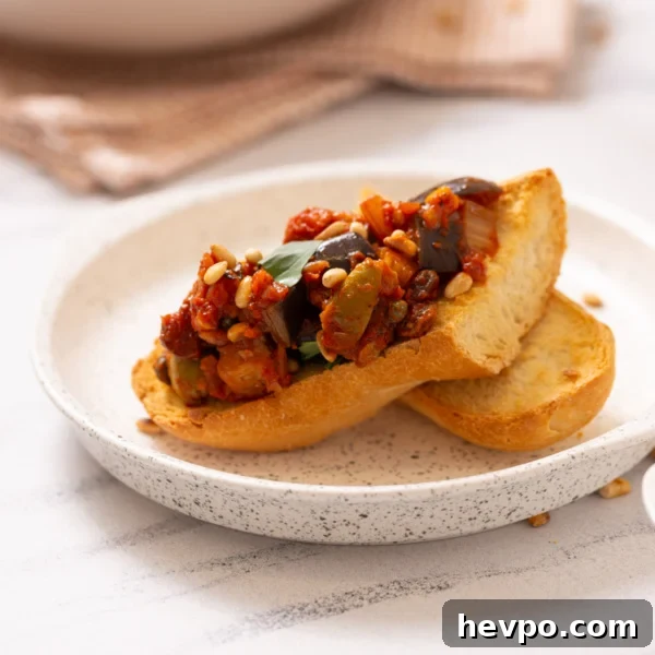 Slow Cooker Caramelized Onions Recipe for Sweet, Hands-Off Flavor 6 A close up image of Sicilian caponata served on a toasted bread.