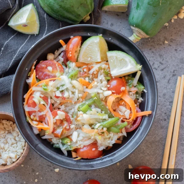 Slow Cooker Caramelized Onions Recipe for Sweet, Hands-Off Flavor 7 Thai green papaya salad with tomatoes, peanuts, and lime wedges served in a black bowl.