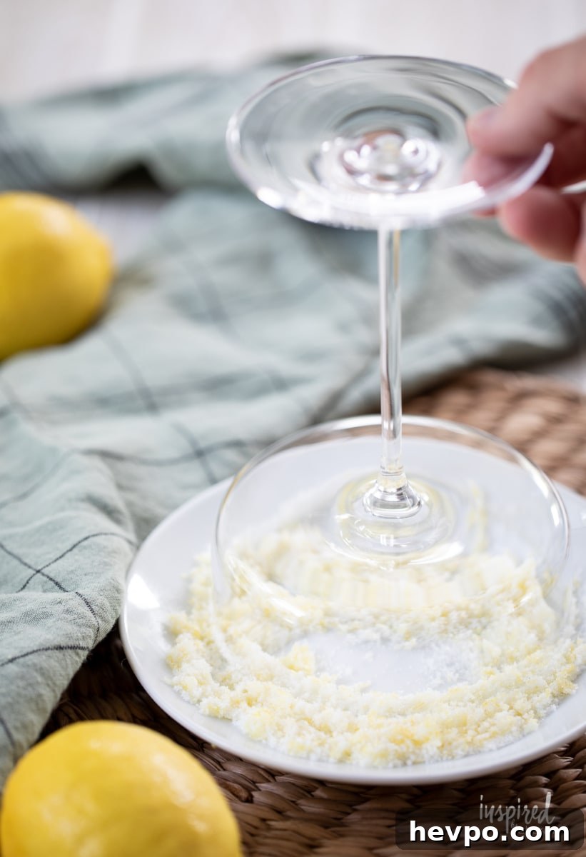 Zesty Lemon Drop Martini Recipe: How to Make the Classic Cocktail 7 rimming martini glass with lemon sugar.