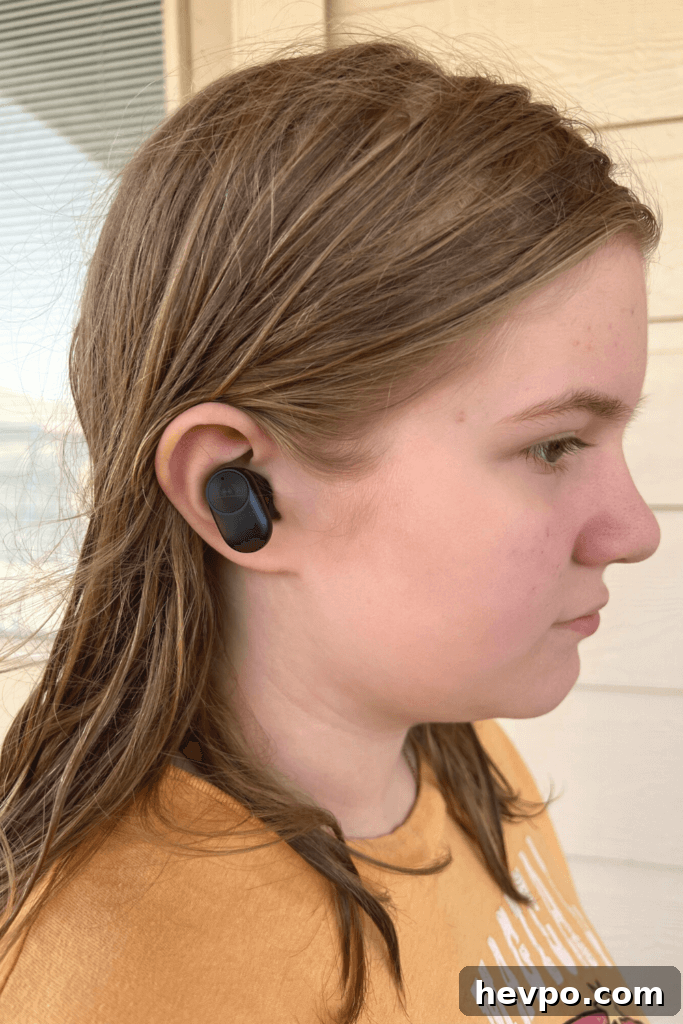 A tween girl wearing a PaMu Slide 2 ANC Wireless Earbud