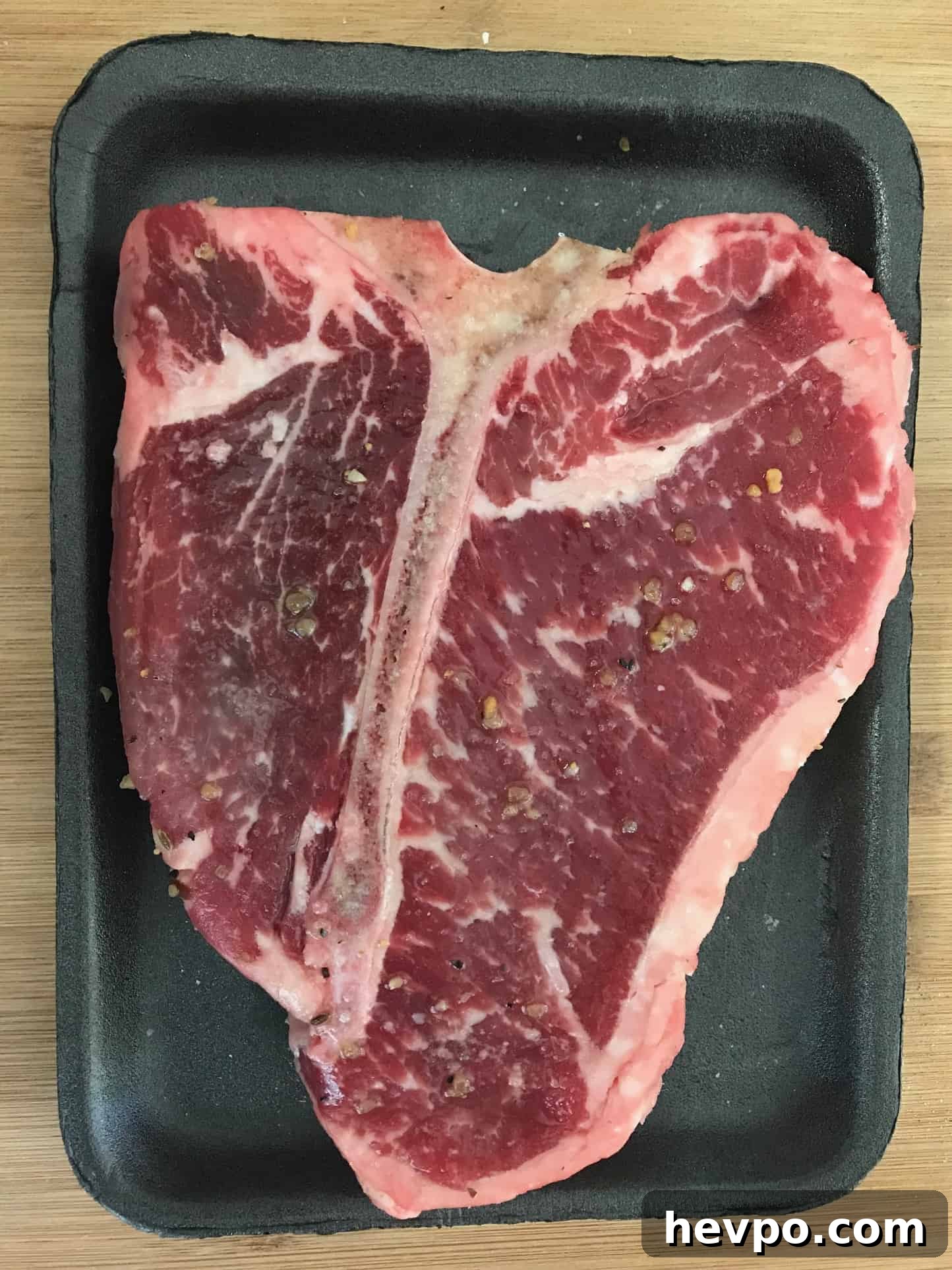 Raw steak in original packaging overhead shot