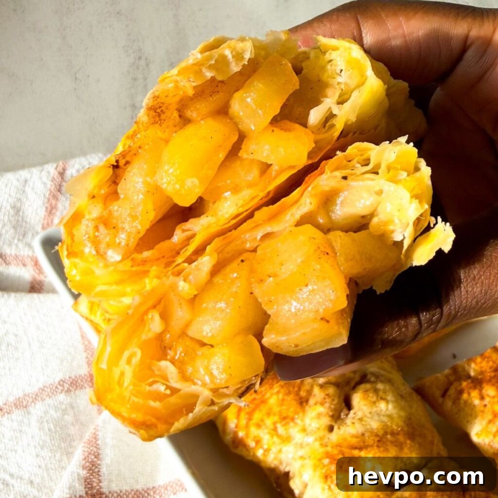 Classic Apple Hand Pies Made with Flaky Puff Pastry 4 Golden brown puff pastry apple hand pies with flakey layers and spiced apple filling.