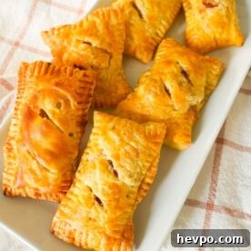 Classic Apple Hand Pies Made with Flaky Puff Pastry 5 Golden brown puff pastry apple hand pies with flakey layers and spiced apple filling.