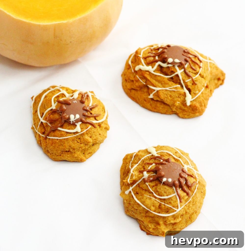 Three pumpkin cookies with chocolate decorations for Halloween