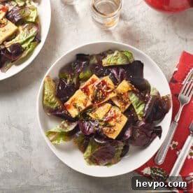 How to Press Tofu for Firmer, Crispier Results 11 Korean tofu salad on plates with red napkins and silverware.