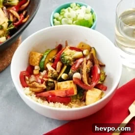 How to Press Tofu for Firmer, Crispier Results 12 White bowl of Stir Fried Crispy Tofu and Vegetables and rice.