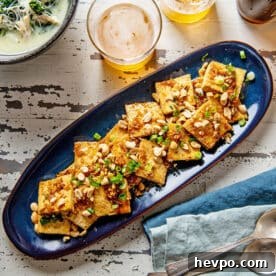 How to Press Tofu for Firmer, Crispier Results 13 Spicy, Sweet and Nutty Tofu on a long blue platter.