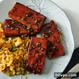 How to Press Tofu for Firmer, Crispier Results 18 Air-fried tofu with sticky Chinese barbecue sauce on white plate with sides.