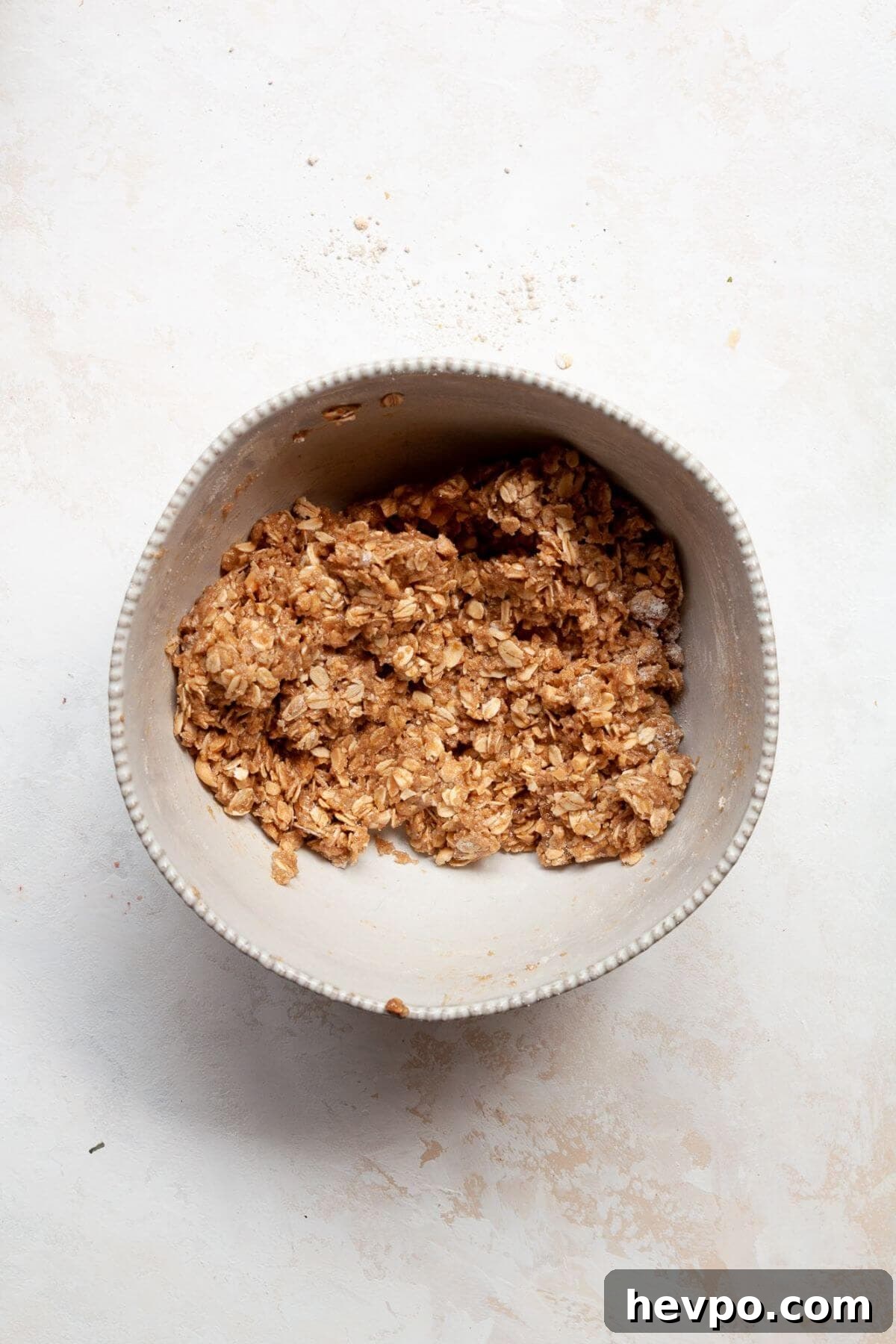 Strawberry Crumble with Oat Topping Recipe 6 Oat flour crumble topping mixed together in a bowl with rolled oats, coconut sugar, and walnuts.