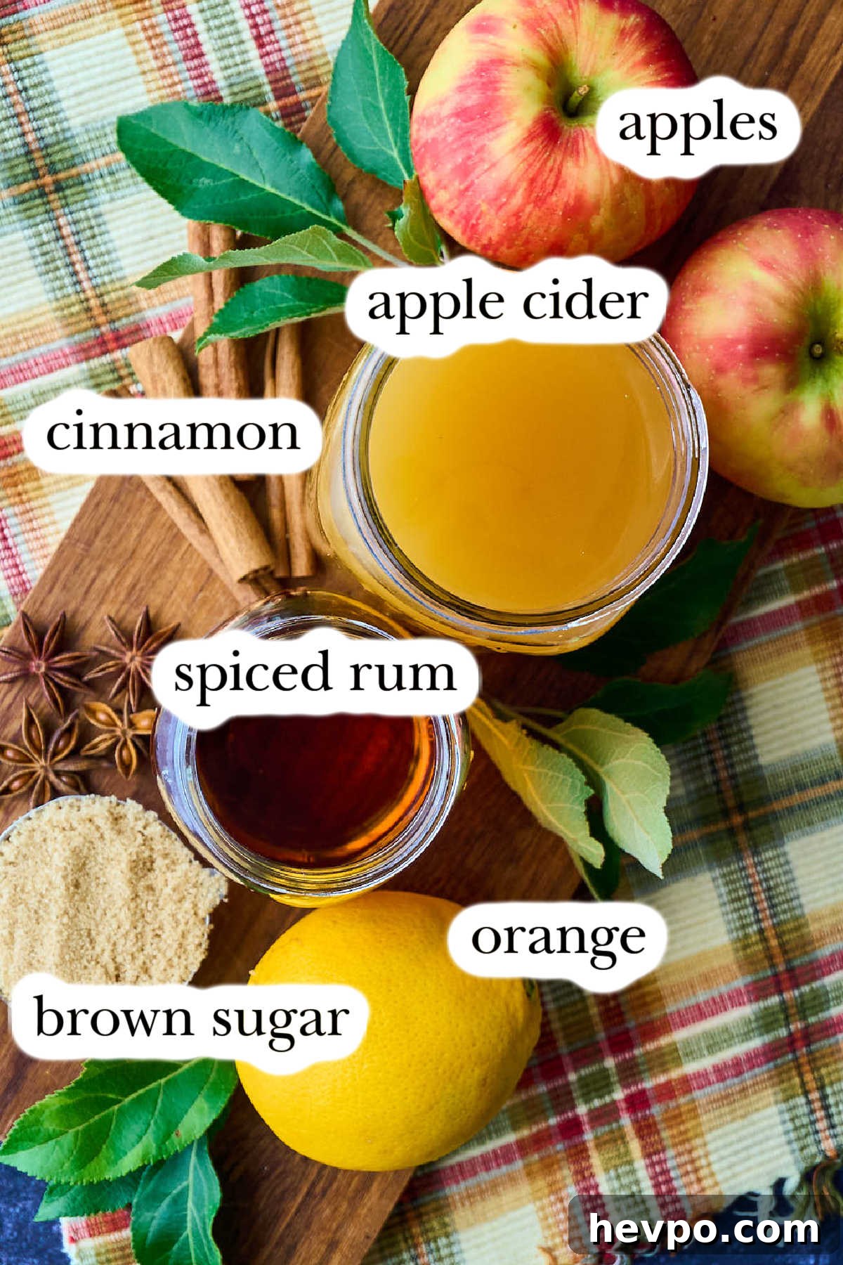 Spiked Slow Cooker Apple Cider Recipe for Cozy Gatherings 3 ingredients and whole apples on plaid cloth