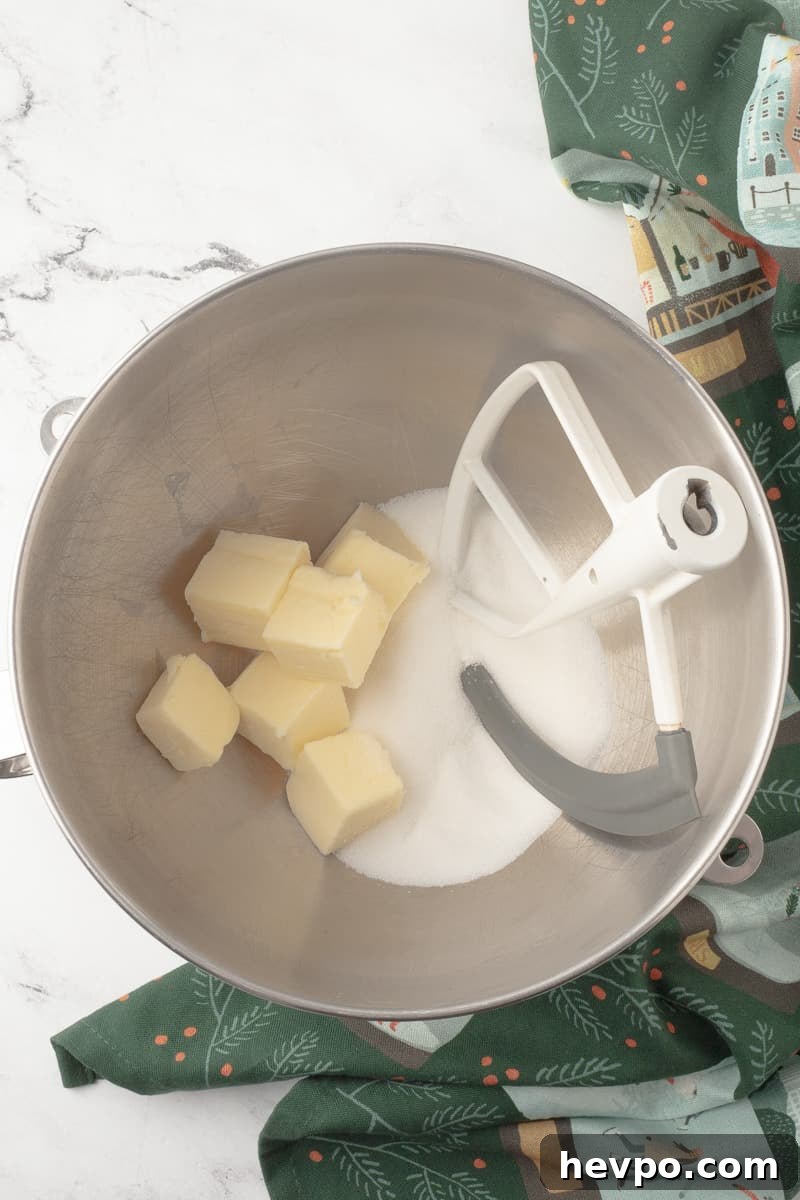 Butter and sugar in mixing bowl from stand mixer with paddle attachment.