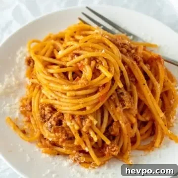 Instant Pot Spaghetti with Savory Meat Sauce 3 Spaghetti swirled on white serving plate
