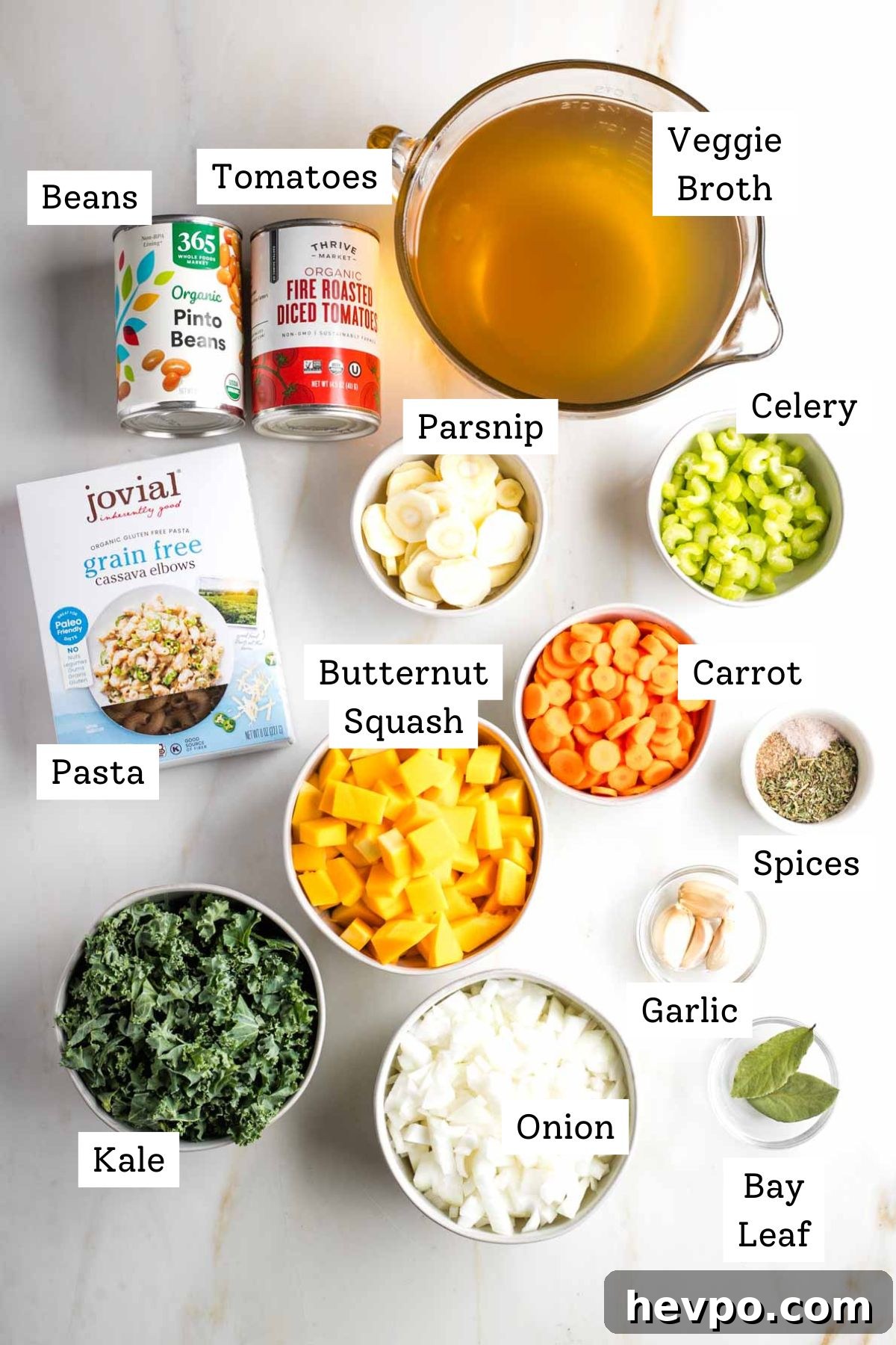 Autumn Vegan Minestrone: Hearty Fall Vegetable Soup 3 Labeled ingredients: veggie broth, canned beans and tomatoes, celery, carrot, parsnip, butternut squash, kale, spices, garlic, pasta.