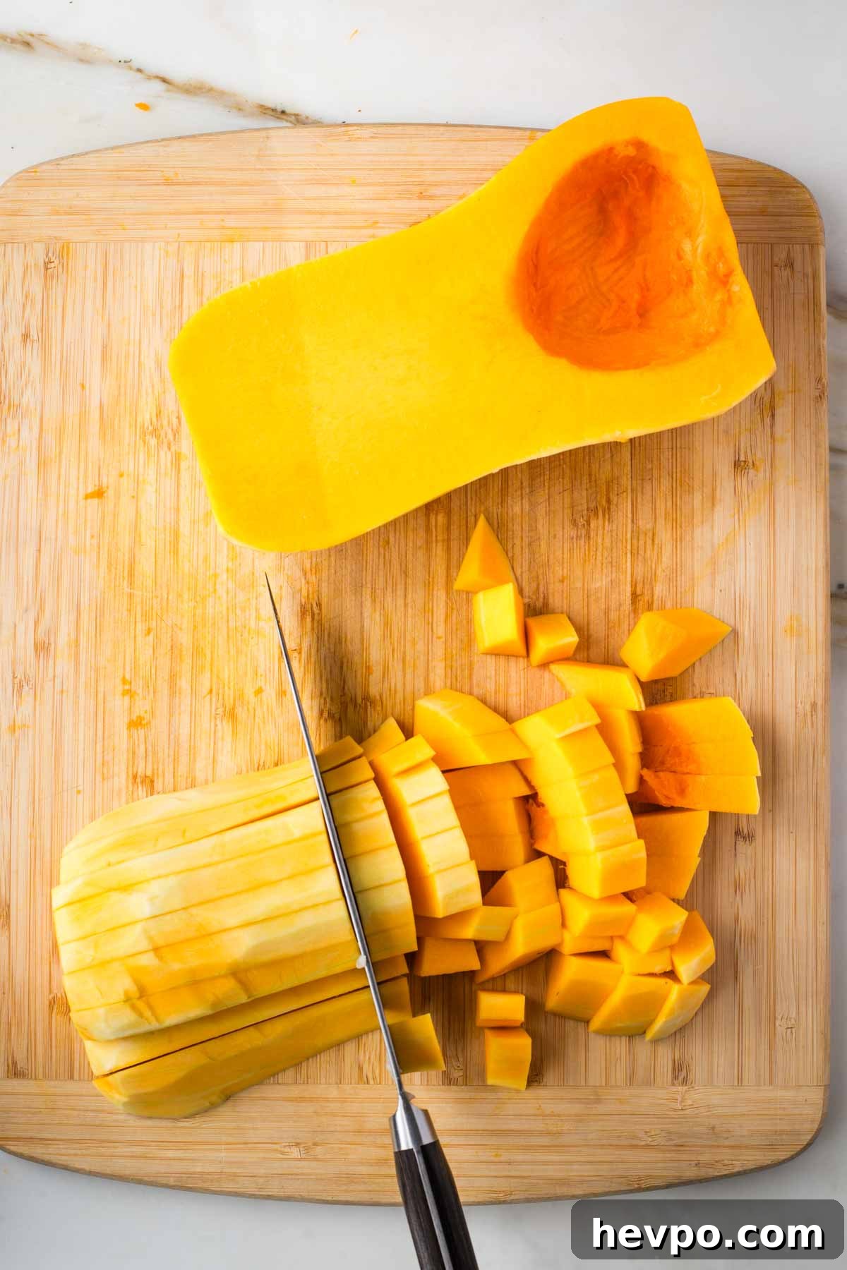 Autumn Vegan Minestrone: Hearty Fall Vegetable Soup 5 Cutting peeled butternut squash into small dice.