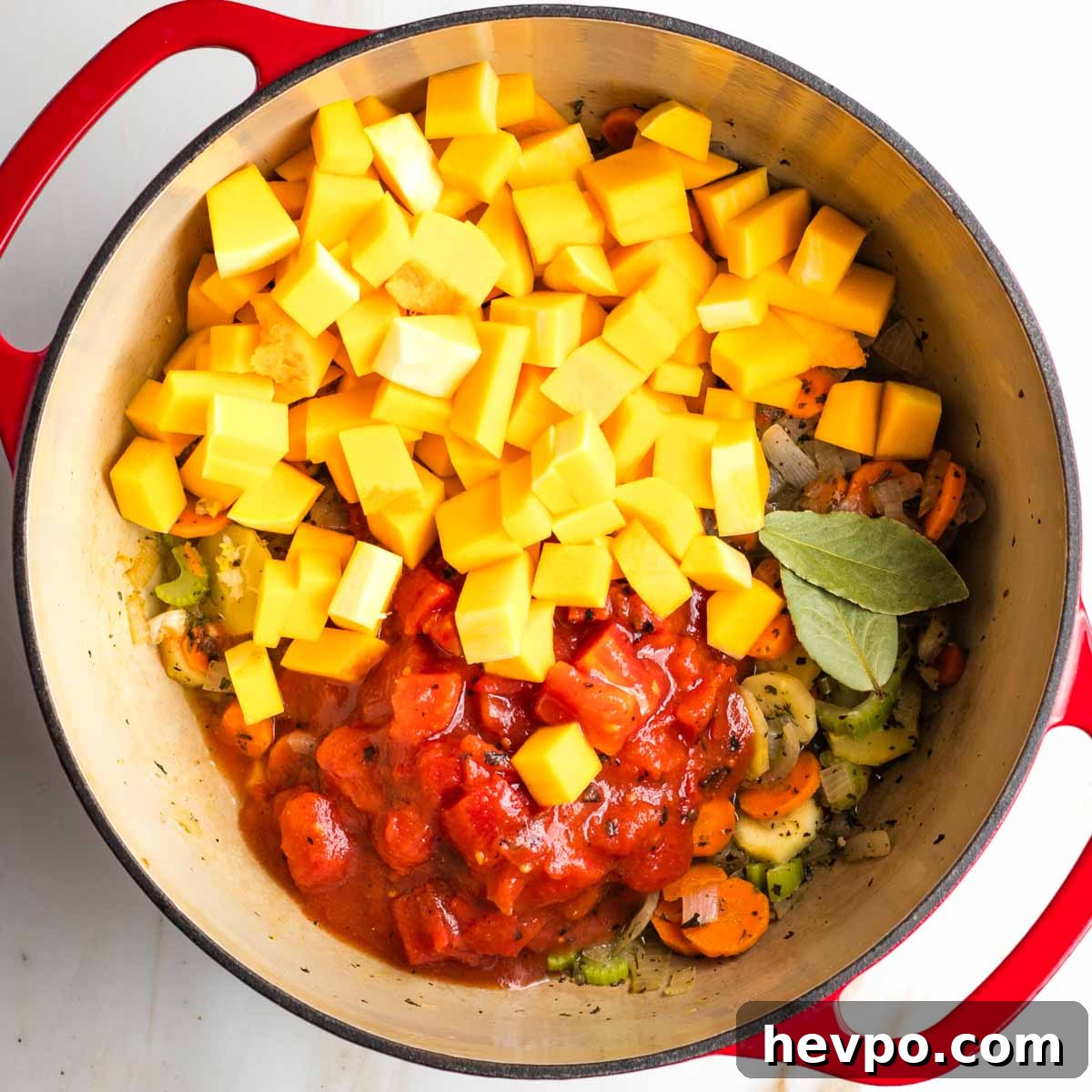 Autumn Vegan Minestrone: Hearty Fall Vegetable Soup 8 Diced butternut squash and canned tomatoes plus bay leaves in a dutch oven with sauteed veggies.