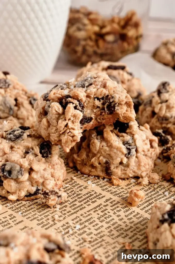 Golden brown oatmeal raisin cookies full of dark brown raisins and whole grain rolled oats.