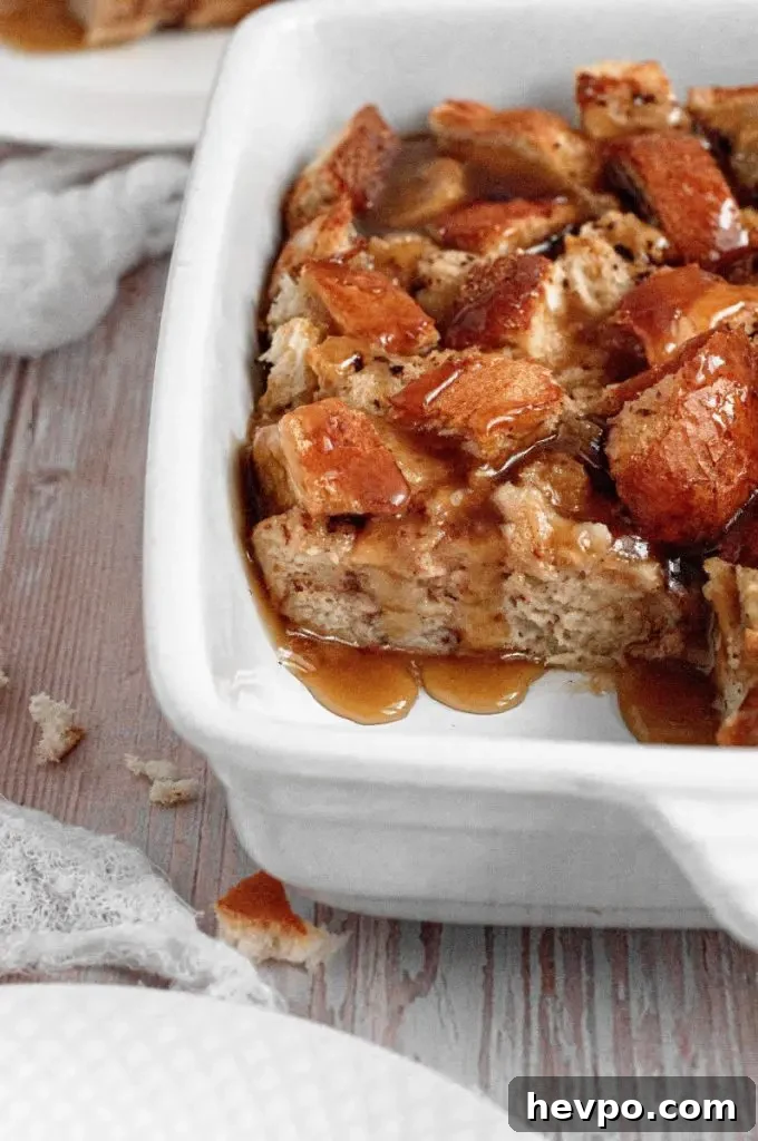 A light golden brown bread pudding topped with toffee sauce.