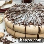 Concord cake (gâteau Concorde) on a marble board with dessert plates in the background.