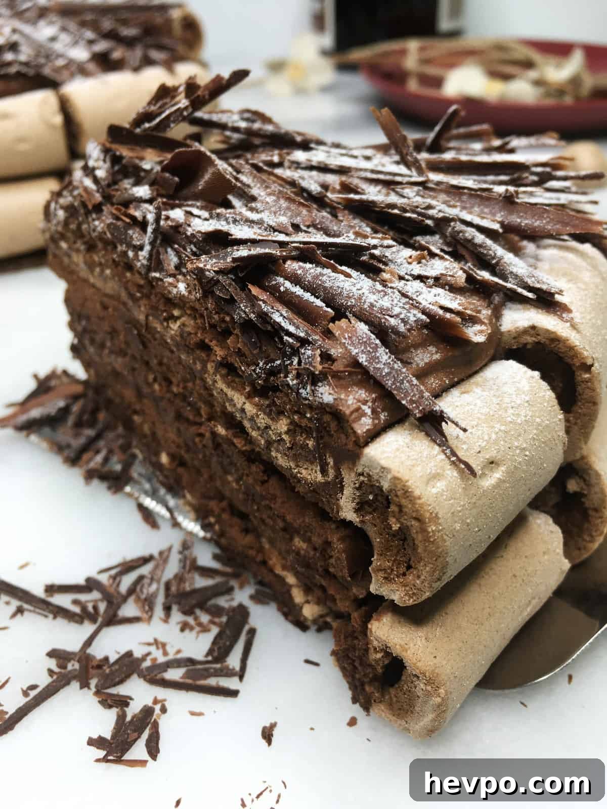 A slice of Concord cake (Gâteau Concorde) with the rest of the cake
