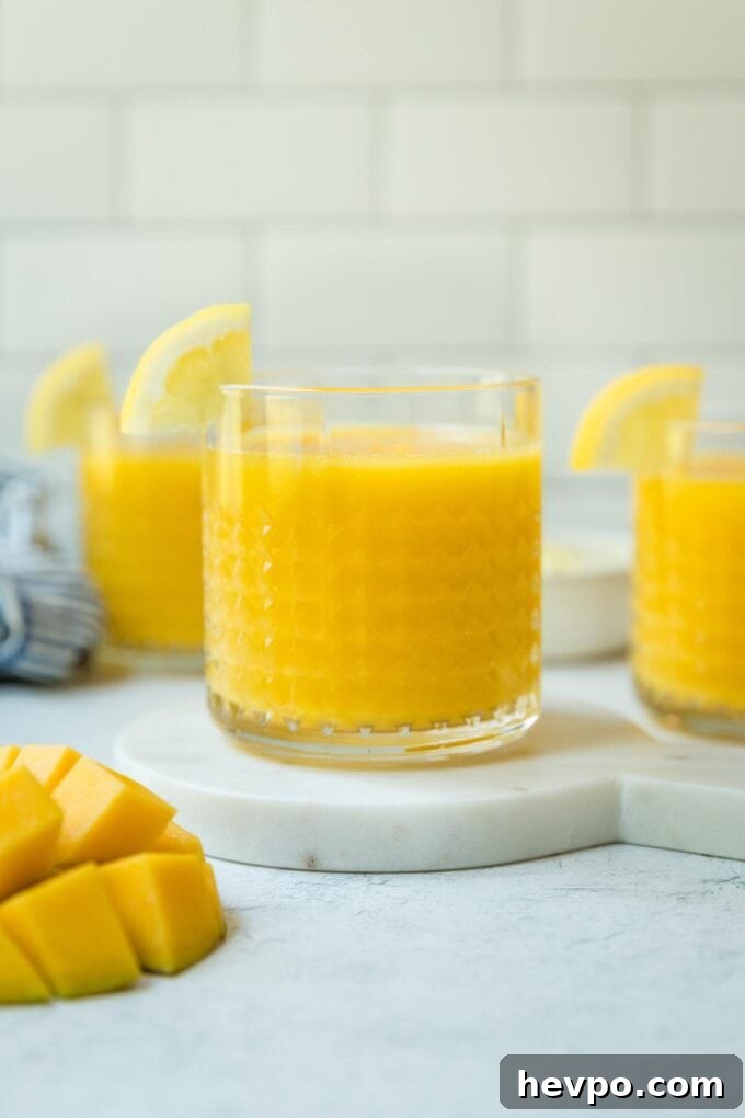 Straight on view of mango frozen lemonade served in small clear glasses.