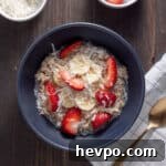Coconut Milk Overnight Oats Recipe for Creamy Breakfast 9 A bowl of overnight oats with coconut milk topped with shredded coconut, berries and maple syrup.