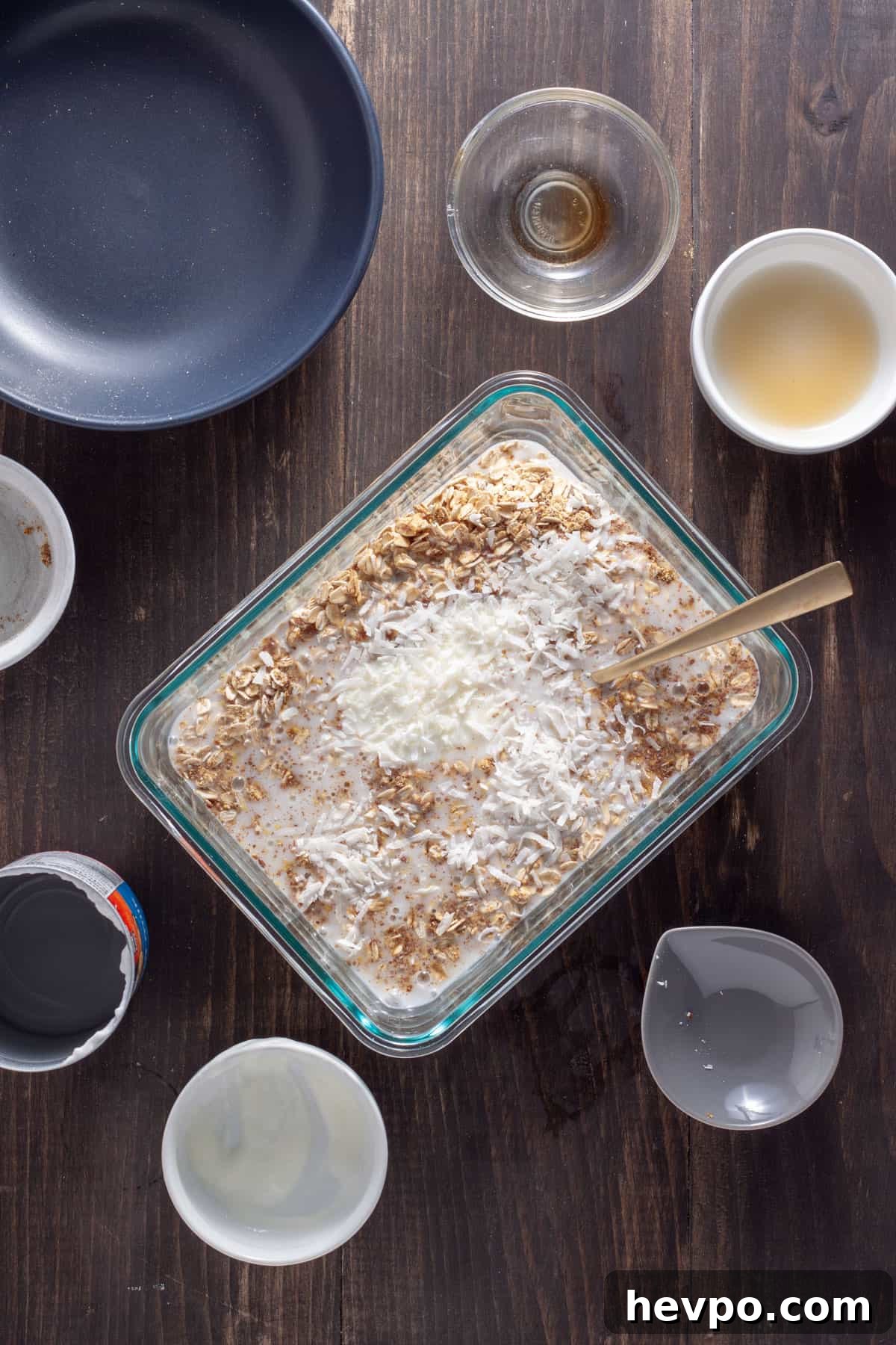 Coconut Milk Overnight Oats Recipe for Creamy Breakfast 4 Overnight oats with coconut milk getting stirred together in a glass container.