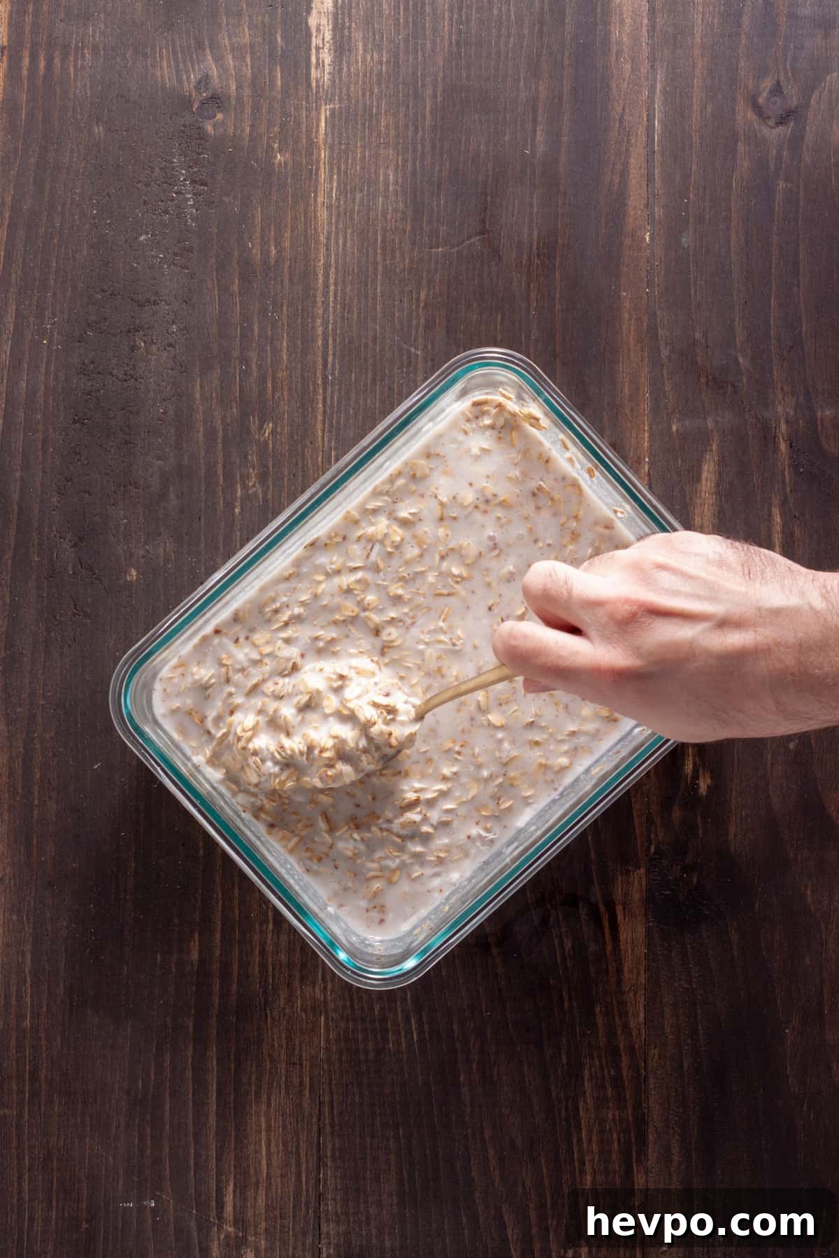 Coconut Milk Overnight Oats Recipe for Creamy Breakfast 5 Overnight oats with coconut milk getting stirred together in a glass container.